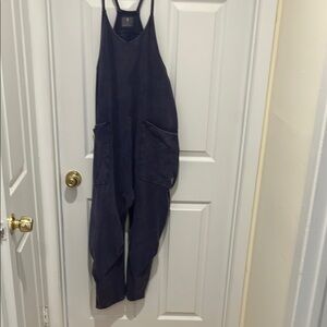 Free People Movement Jumpsuit in dark purple jersey fabric.